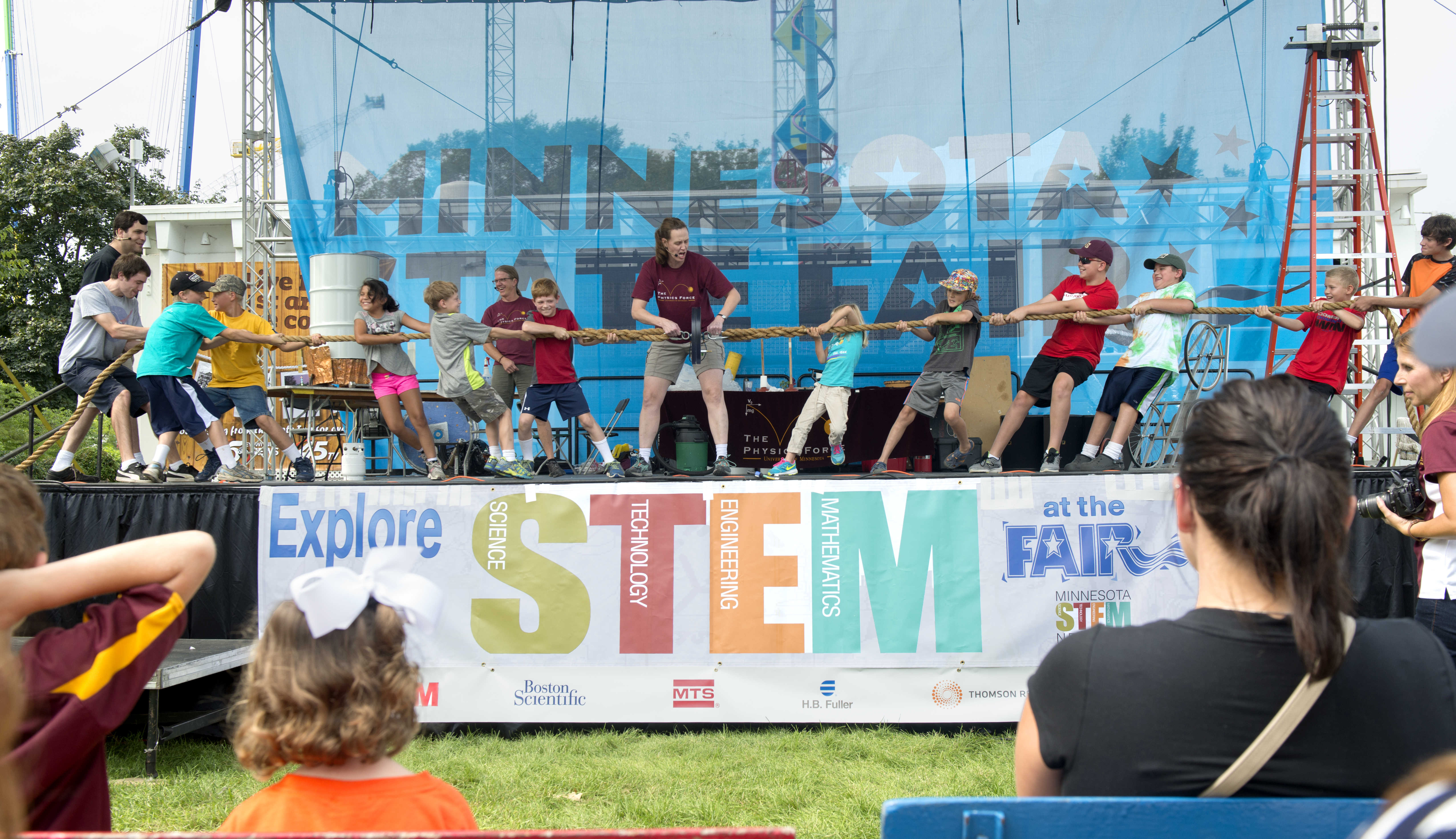 UMN students work with kids at a STEM station at the State Fair