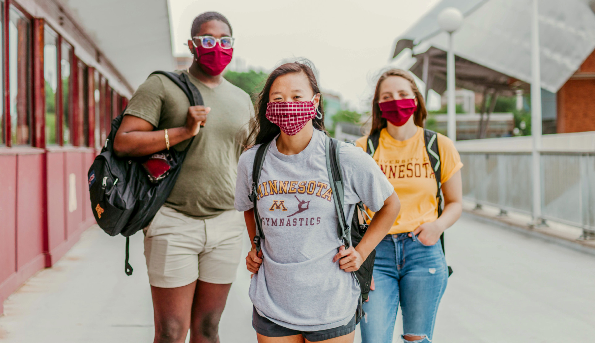 Students stand on the Washington bridge while wearing masks